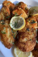 parmesan crusted chicken breasts in lemon butter garlic sauce plated
