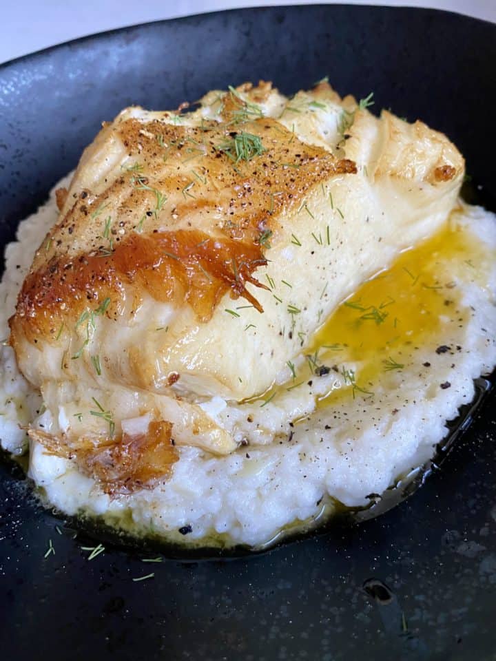 lemon butter chilean sea bass plated with dill