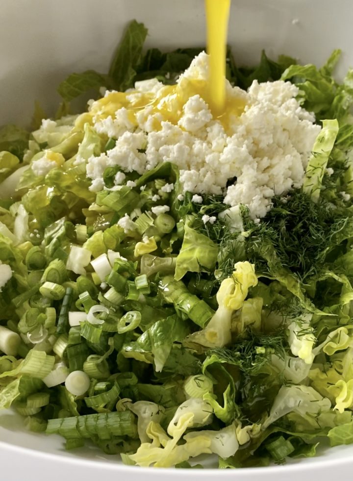 maroulosalata ingredients with dressing pour