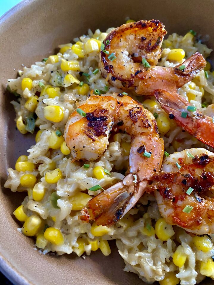 spicy shrimp with creamy corn rice close up