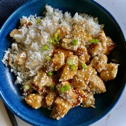 sesame chicken plated with rice