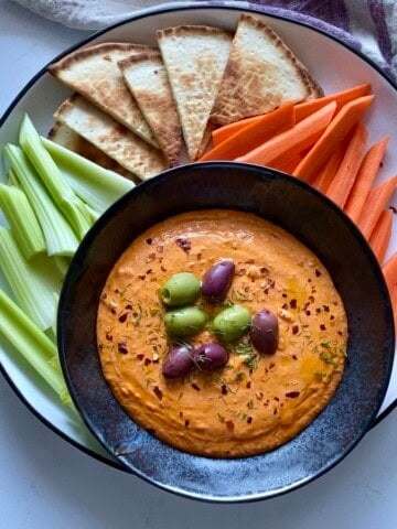 spicy feta dip with carrots celery and pita chips