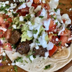 steak tacos with guacamole and lime crema
