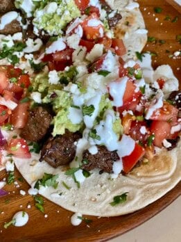 steak tacos with guacamole and lime crema