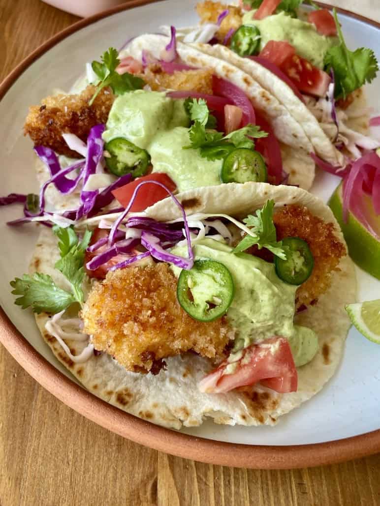 crispy fish tacos with creamy green avocado sauce
