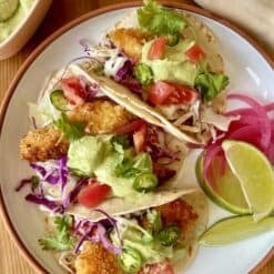 crispy fish tacos with creamy green avocado sauce