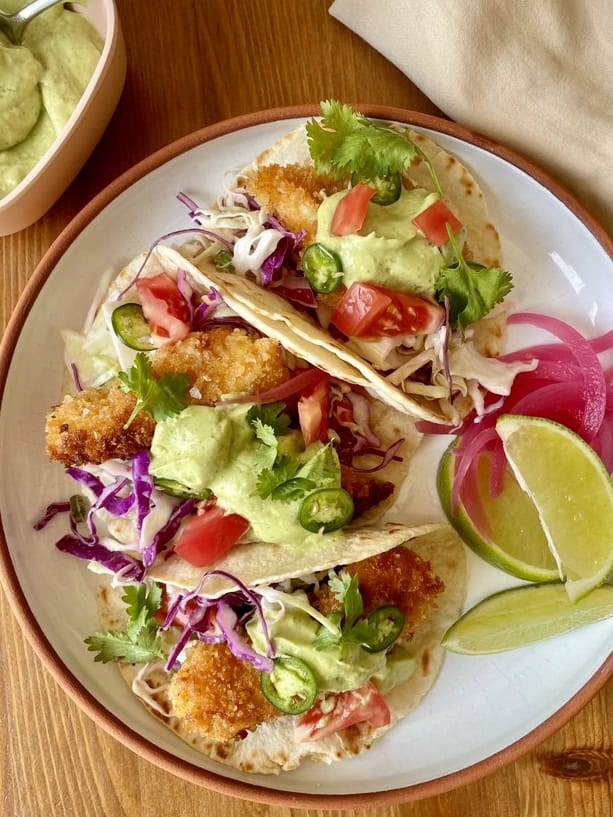 crispy fish tacos with creamy green avocado sauce